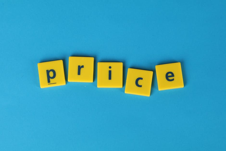 A close-up view of five yellow plastic tiles with blue letters spelling the word 'price' against a solid light blue background. The tiles are arranged in a slight arc, with the letters 'p', 'r', 'i',